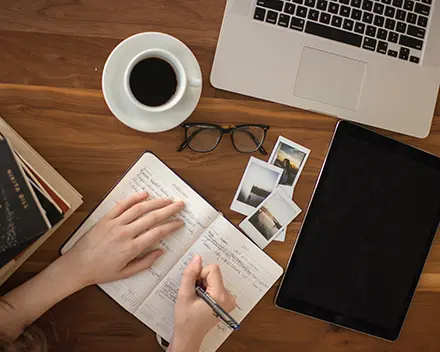 Person making plans and working with a cup of coffee